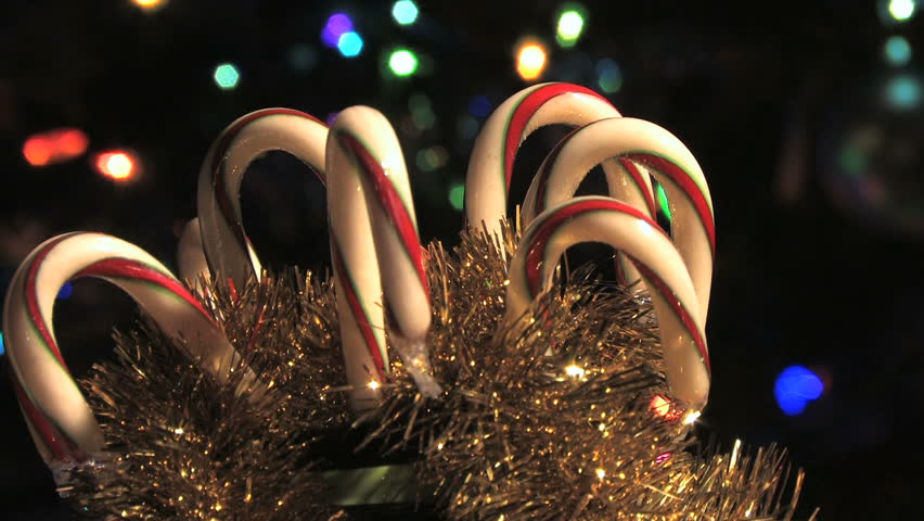 Candy canes rotating in holiday scene. (HD)