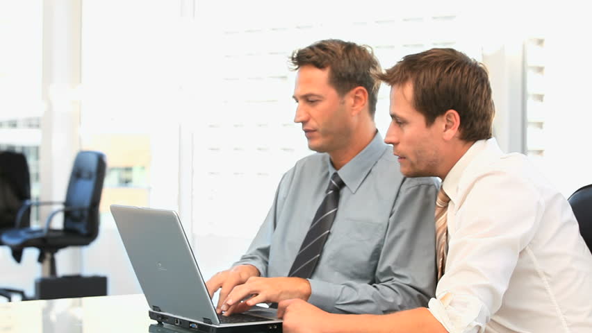 Coworkers working together on a laptop