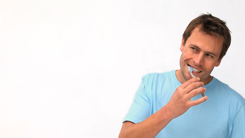 Handsome guy brushing his teeth