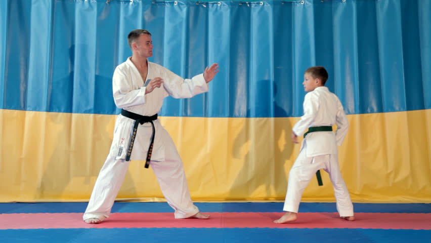 Boy learning from his karate instructor