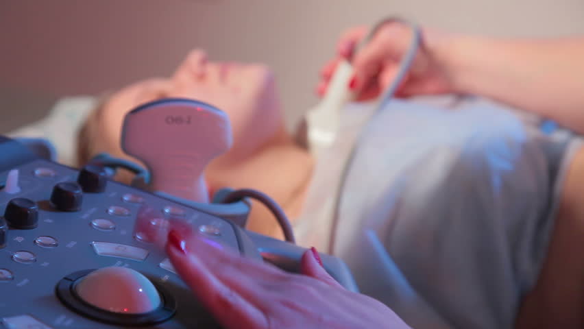 A woman make ultrasonic research of the neck