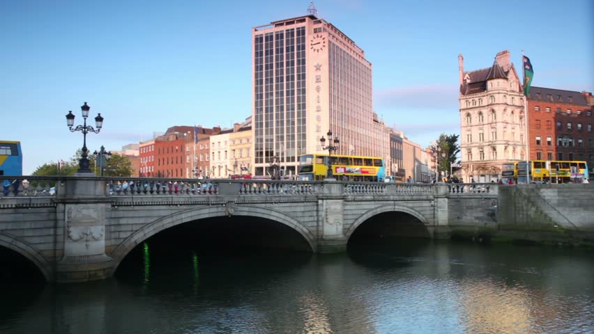  DUBLIN - JUNE 10: Cars and passer-by on Ha'penny Bridge bridge, June 10, 2010 in Dublin, Ireland. The Ha'penny Bridge, built in 1816, is the oldest pedestrian bridge over the Liffey River.