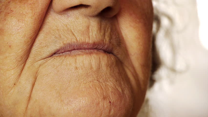 Senior old woman smile mouth wrinkle skin close up 