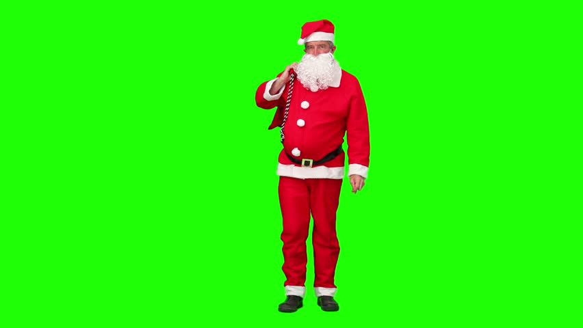 Chromakey footage of a Santa Claus holding a bag of gift and dancing