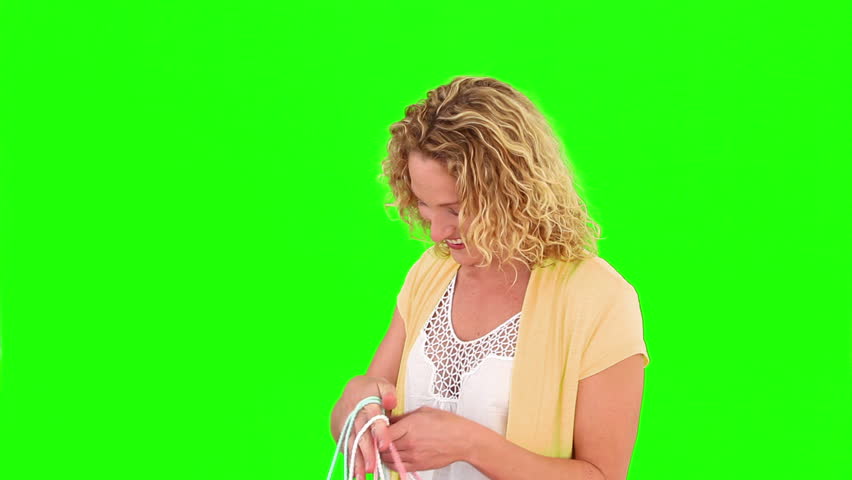 Chromakey footage a curly blond haired woman holding shopping bags