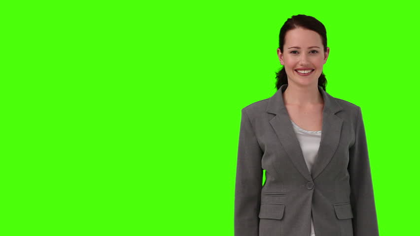 Chroma-key footage of a dark-haired woman in suit looking at the camera