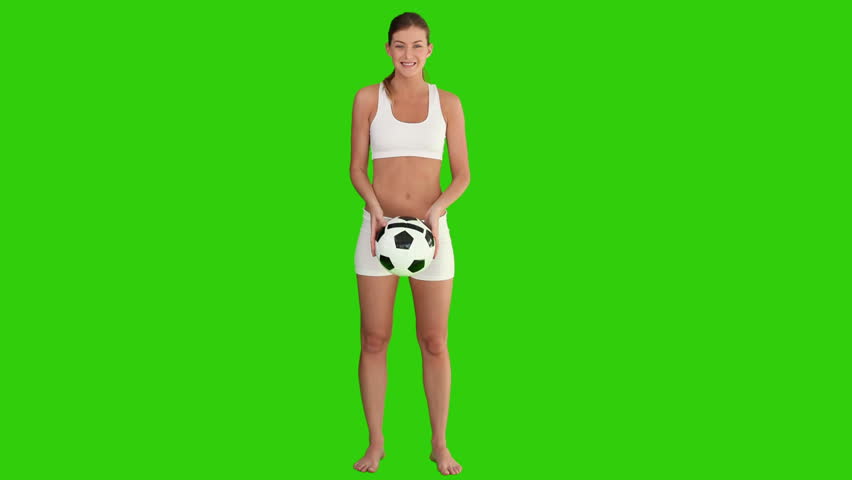 Chromakey footage of a pretty brown-haired woman playing with a soccer ball