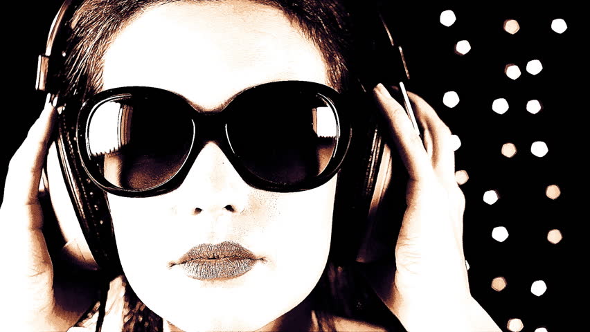 close-up of the face of a beautiful woman wearing sunglasses and headphones, listening to music