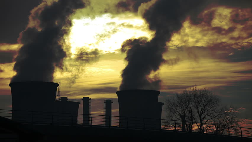 Power plant. Visible flock of birds. Smoke, steam, pollution discharged from a coal powered electrical generation facility.