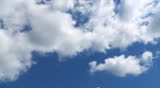 Time lapse of clouds passing in front a blue sky