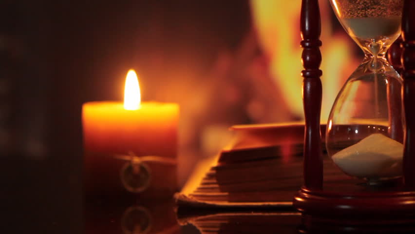 hourglass with an open book. dolly shot.