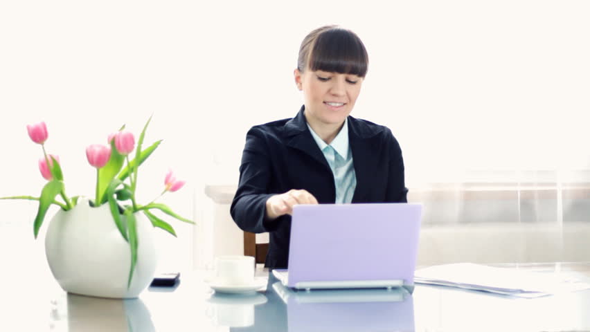 Happy businesswoman finishing her work and throwing documents in the air, slow motion, shot at 60fps