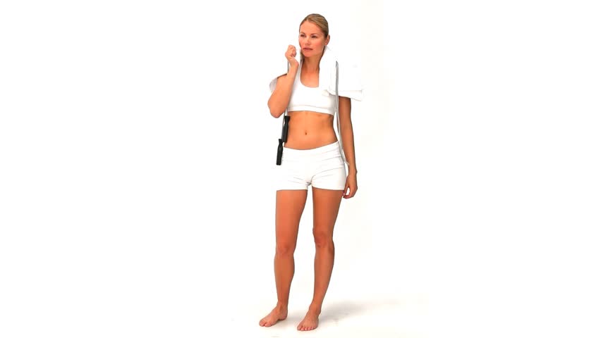 Blonde woman in sportswear with a jump rope and towel against a white background
