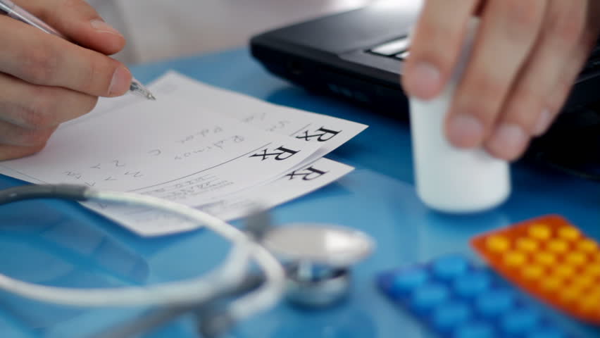 Male doctor writing rx prescription