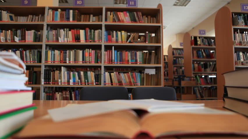 Teenage boy and girl working together in library - time lapse