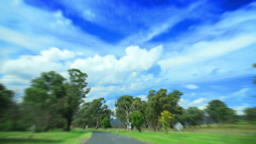 hd time-lapse driving on the road along forest and fields