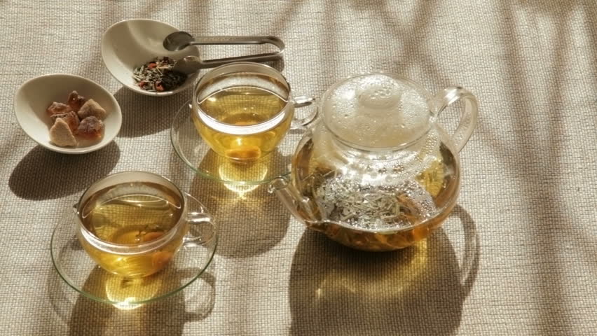 Woman mixes brown sugar with spoon in two cups of tea, 1080p, 29.97 fps, 1/30