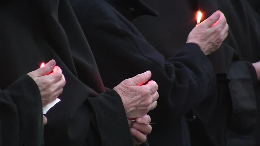 monks with candles in their hands