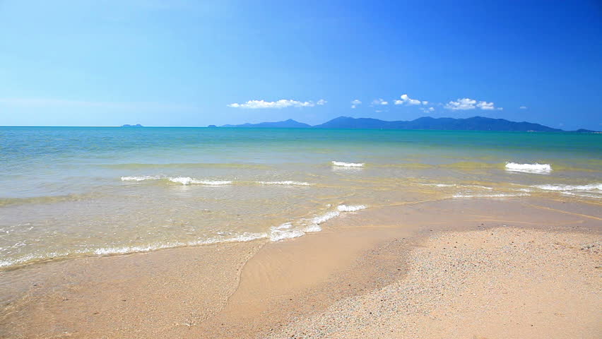  waves landing on sandy beach