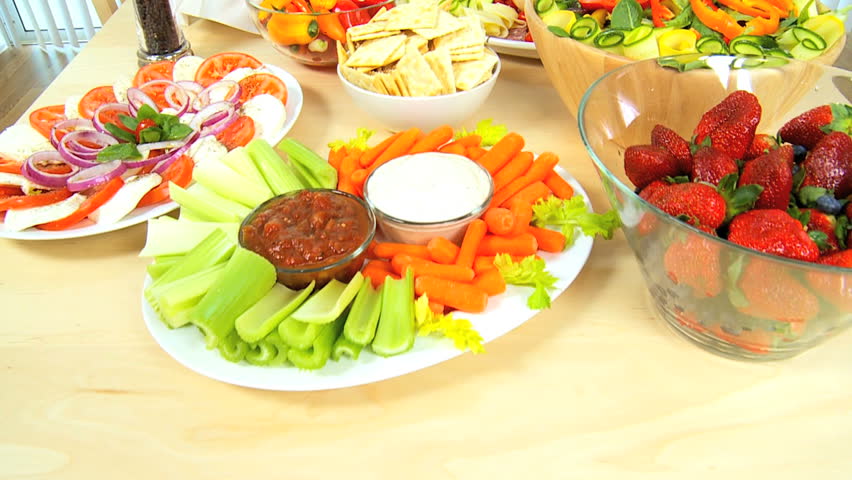Table laid with delicious fresh fruit & vegetables as part of a healthy lifestyle diet
