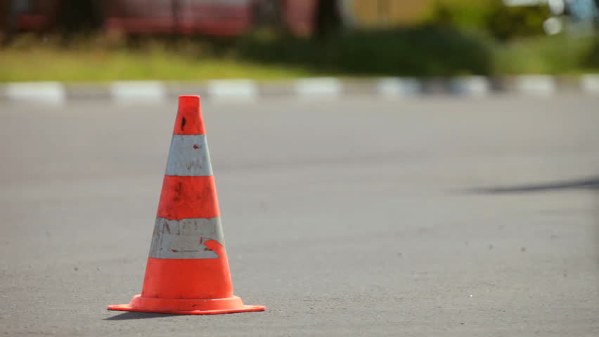 Traffic cone in the background moving cars