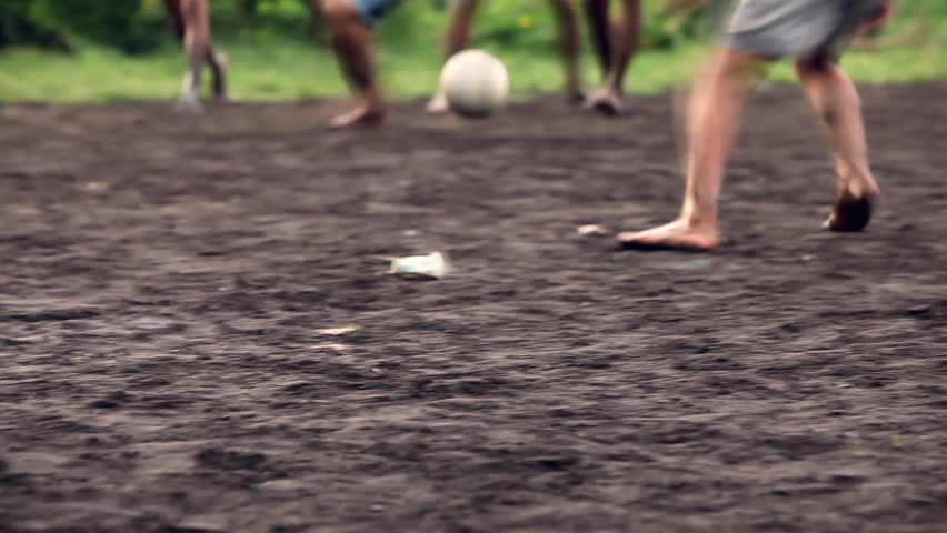 A gang of bar feet kids playing soccer on a muddy field. Serial of slow motion shots with depth of field effects. Action loaded details of running legs and goal shots. [b]HD1080 | 30fps[/b]