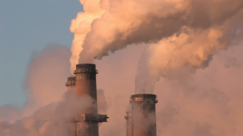 Close of pollution, smoke and steam discharged from a coal powered electrical generation facility in New Mexico. Contamination, pollution causing global warming and climate change. Fast.