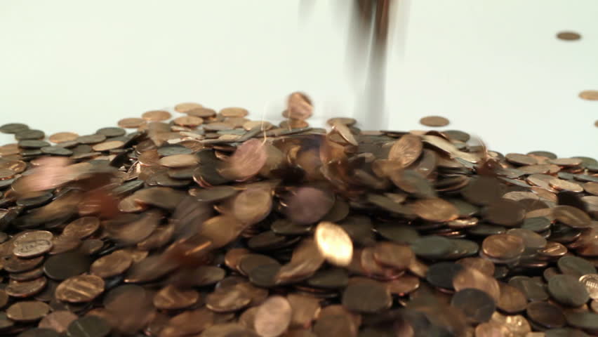 Pennies falling on to a white background
