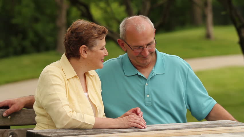 Senior couple, man giving woman flowers