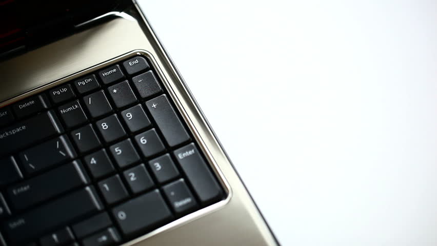 Male hand inserting/ejecting a disc from a laptop.
