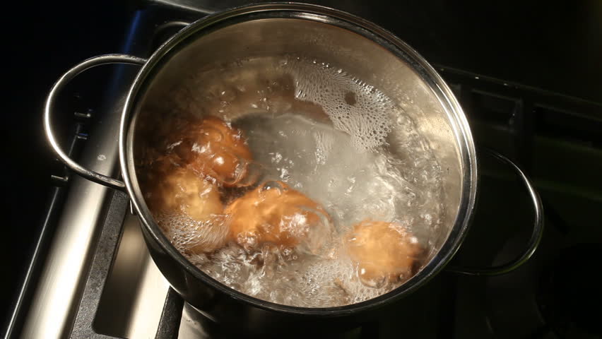 Eggs boiling rapidly on a gas stove