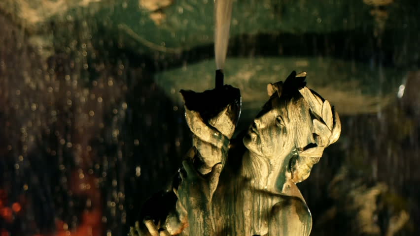 Night time video of a fountain statue.