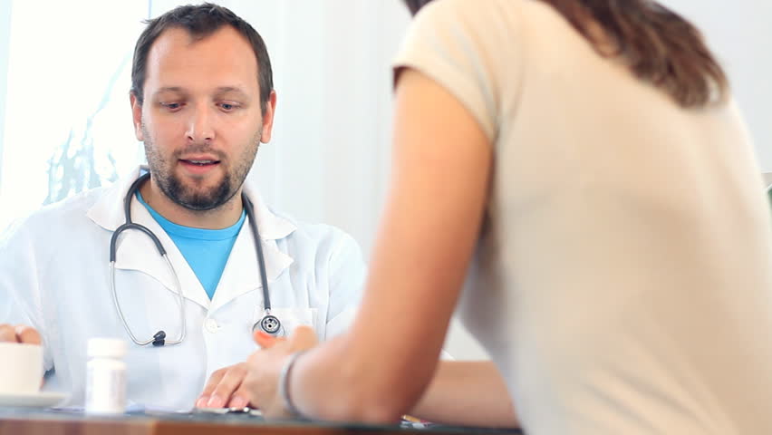 Male doctor telling good news to female patient