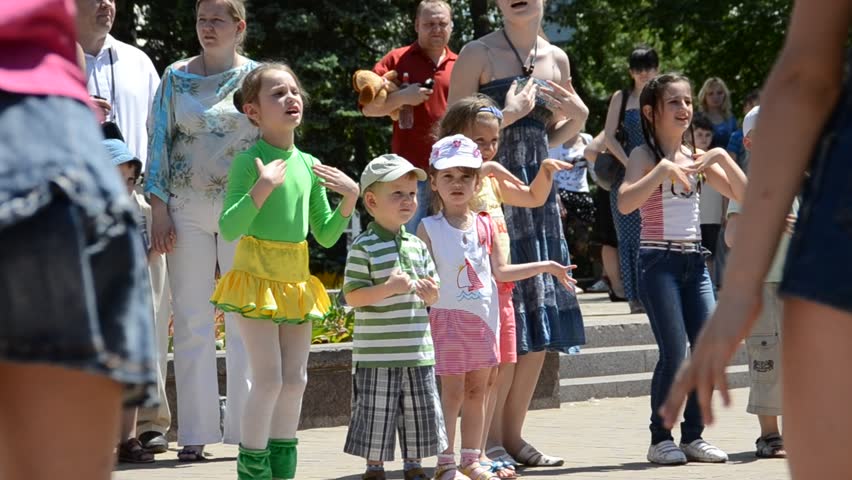 DONETSK, UKRAINE - MAY 29: Children dance in a circle with  parents in celebration of Children's Day, May 29, 2011 in Donetsk, Ukraine. First proclaimed by the United Nations General Assembly in 1954, Children's Day is observed around the world. 