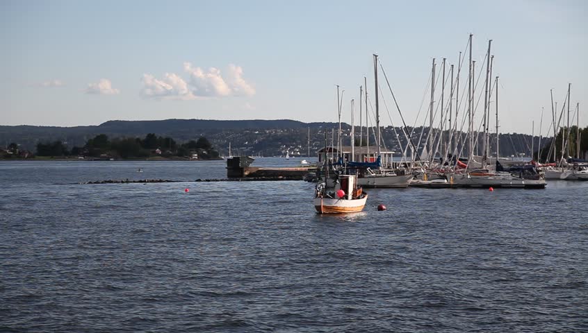 Boat at makefast in Oslo fjord with marina behind Full HD