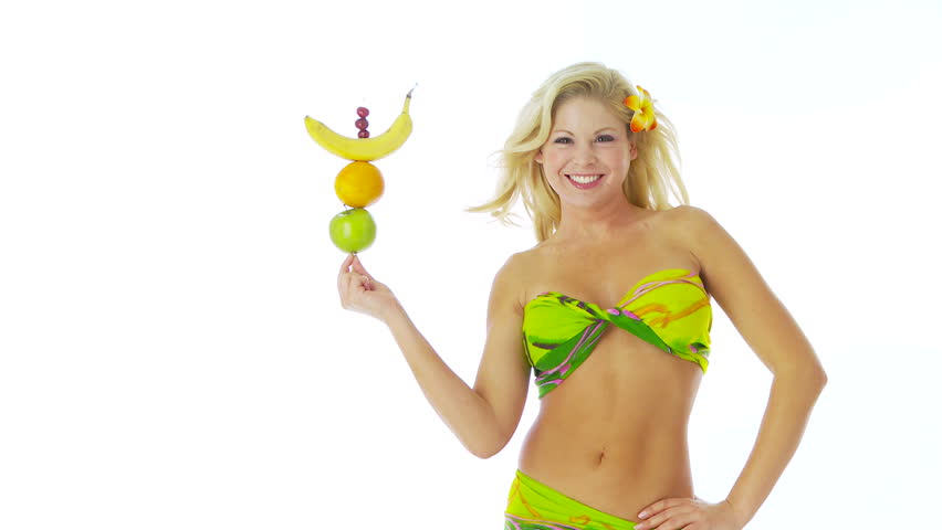 Woman balancing fruit on finger