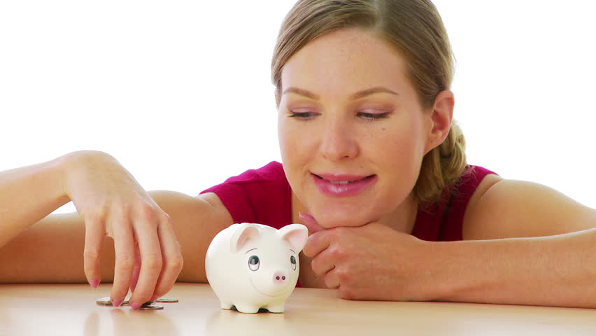 Woman putting money in piggy bank