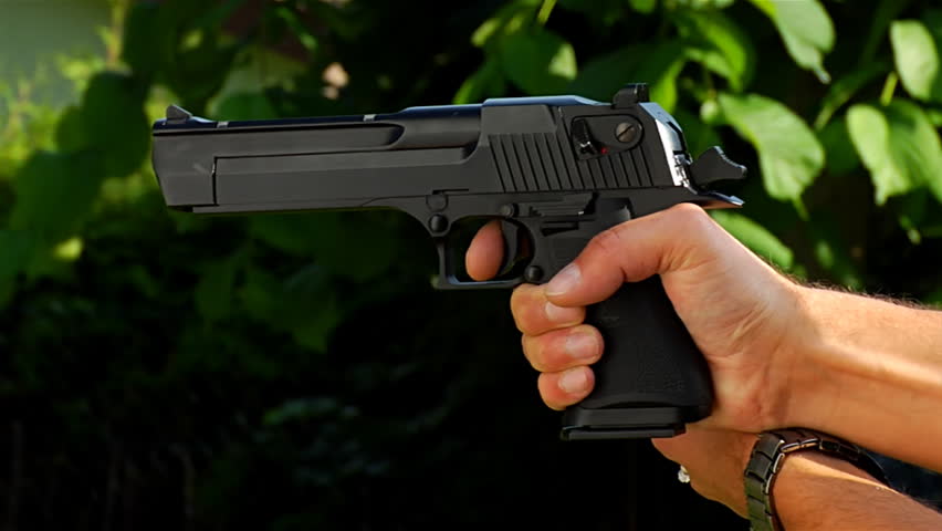 slow motion of a young person shooting with air-soft gun replica