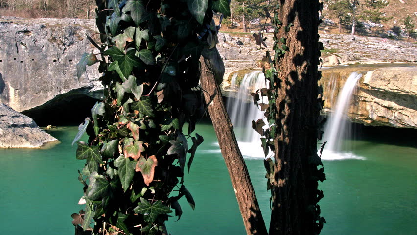 Description: Waterfall and lake Zarecki krov with the trees, shot with the tracks