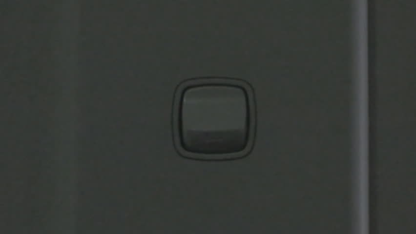 Turning on a switch bringing up ceiling lights in different rooms of a modern office