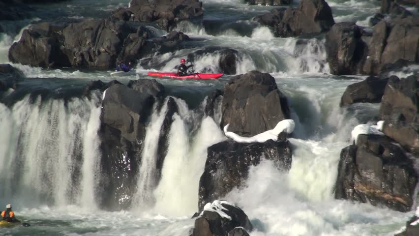 A kayaker plunges off a rapid