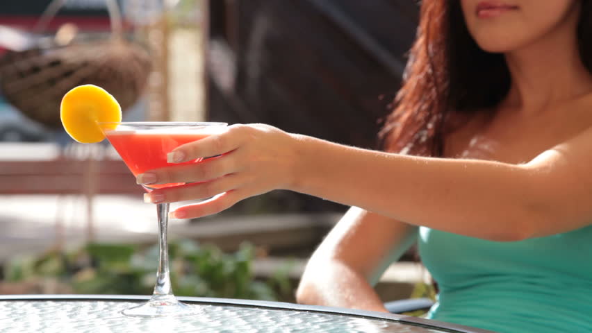 unrecognizable woman drinking cocktail in restaurant