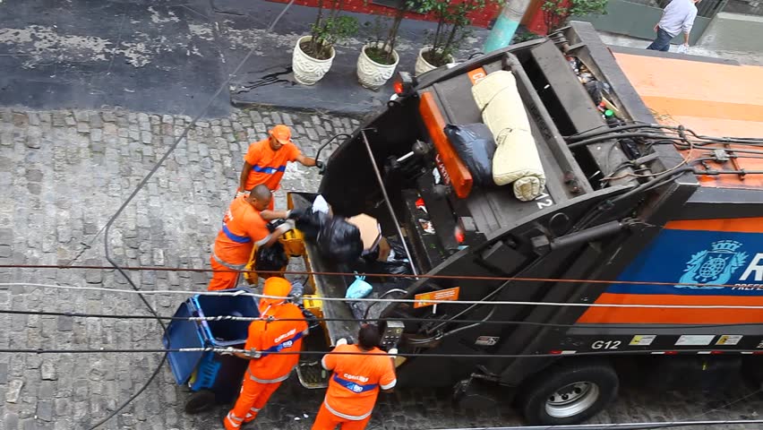 RIO DE JANEIRO, BRAZIL - JUNE 22: Municipal workers collect garbage, Rio de Janeiro, Brazil June 22, 2011. In 2008 the federal government began the work of slum upgrading and sanitation in an effort to mitigate problems aflicting Rio's poorest regions.
