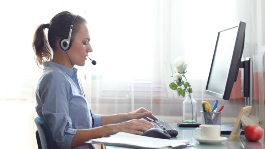 Attractive helpdesk consultant talking on headset