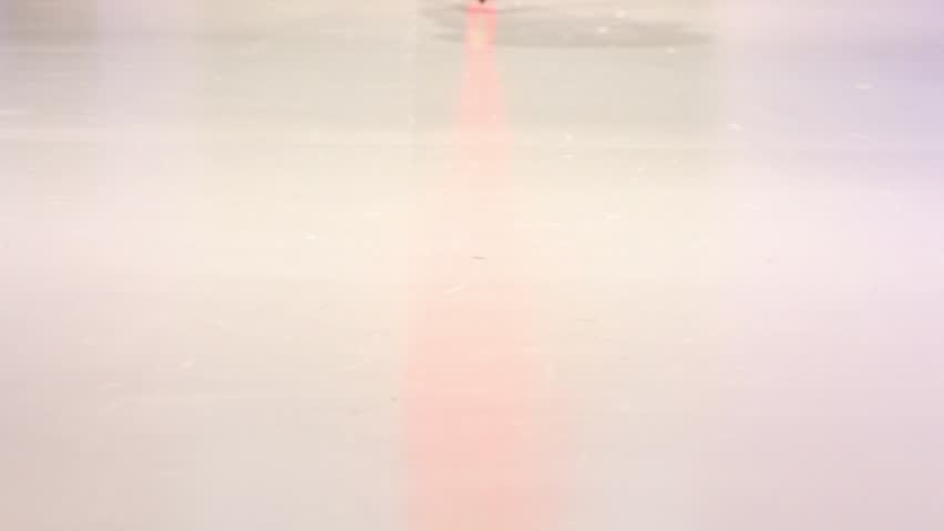 Woman walk in red shoes and red stocking by podium surface, only legs visible