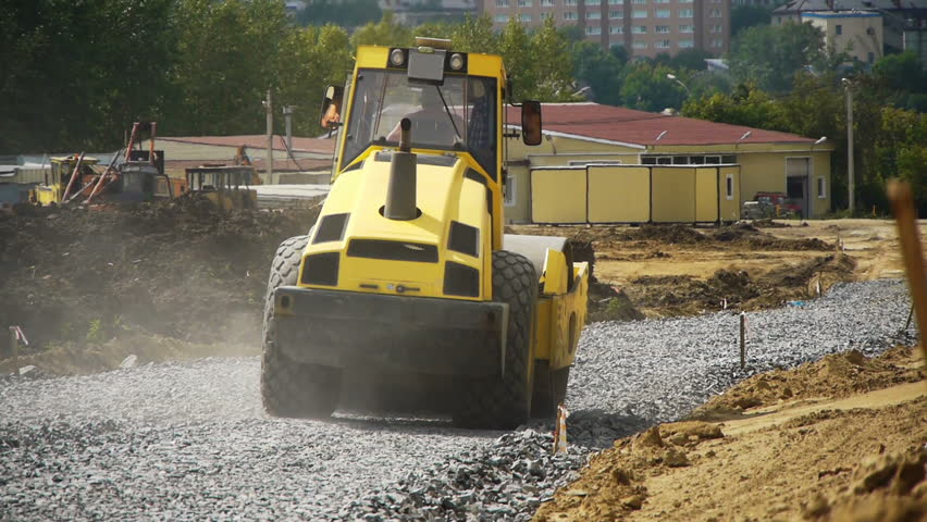 a road construction by a red road roller