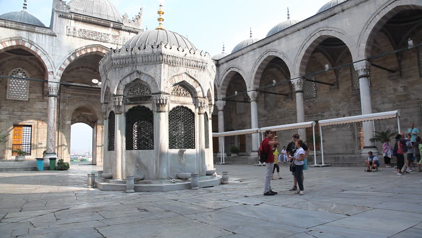 ISTANBUL TURKEY - JULY 30: Tourists visit the Yeni Cami Mosque in Istanbul July 30 2011. The Yeni Camii, The New Mosque or Mosque of the Valide Sultan is an Ottoman imperial mosque located in the EminÃÂ¶nÃÂ¼ district of Istanbul, Turkey. 