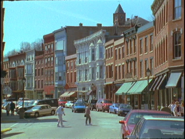 Pedestrians cross a small town main street.