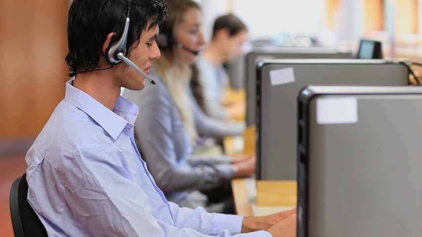Handsome man working in a call center