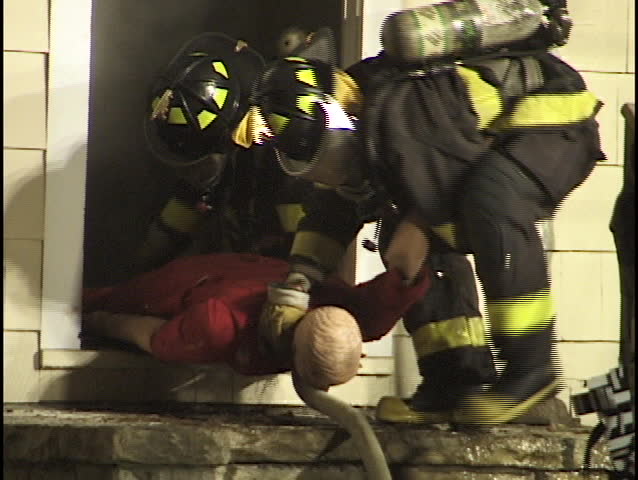 firemen pull dummy out of house